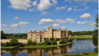 Leeds Castle in Kent, England, surrounded by a serene lake and lush greenery