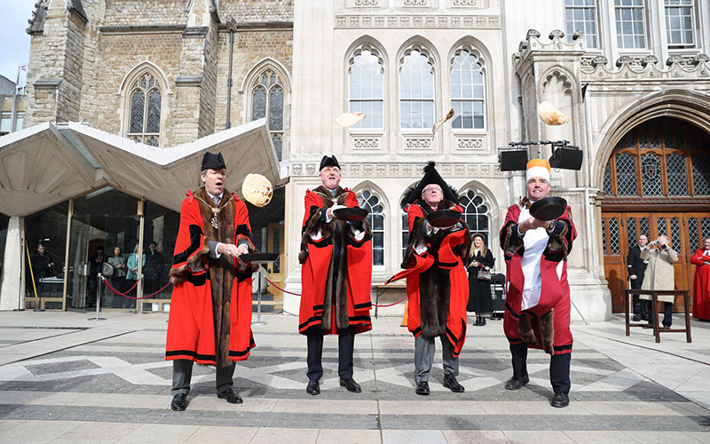 Participants competing in the Inter-Livery Pancake Race in London