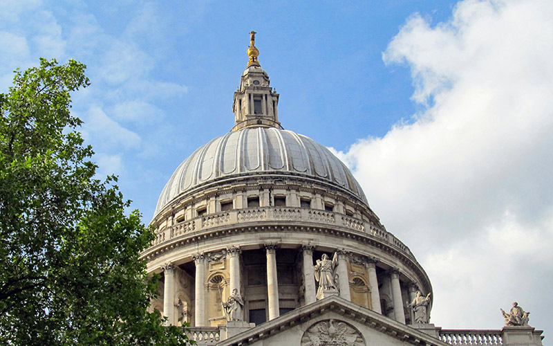 Saint Paul's Cathedral dome in London against a cloudy sky