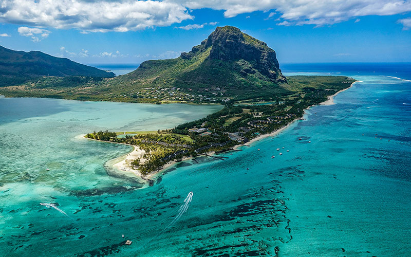 Scenic view of Paradise, Mauritius with blue waters and lush greenery.