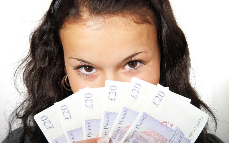 Woman holding UK banknotes